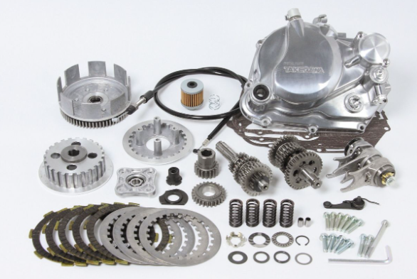Collection of mechanical parts including gears and springs on a white background