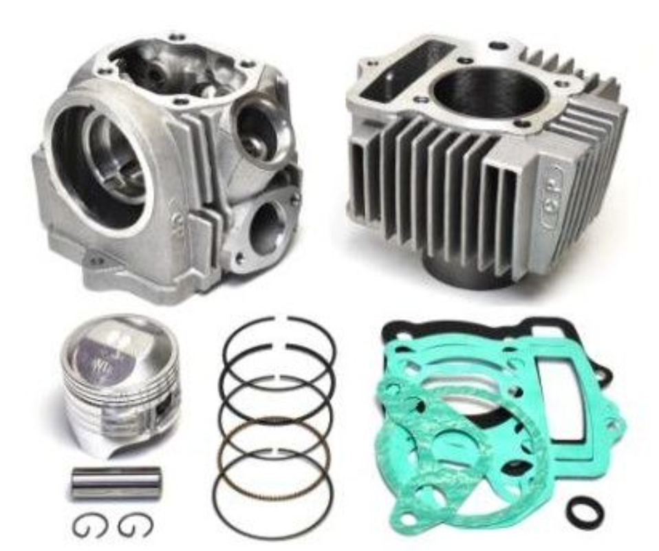 Engine cylinder head, piston, rings, and gaskets on a white background