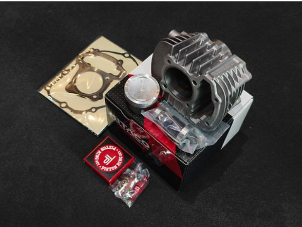 Engine parts including a cylinder head and gaskets on a black background