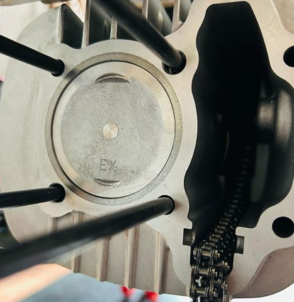 Close-up of a mechanical component with 'EX' marking on a white background