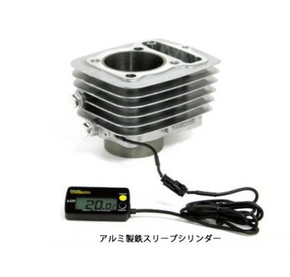 Metallic engine cylinder with digital thermometer on a white background