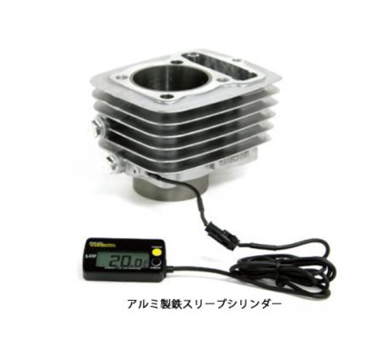 Metallic engine cylinder with digital thermometer on a white background