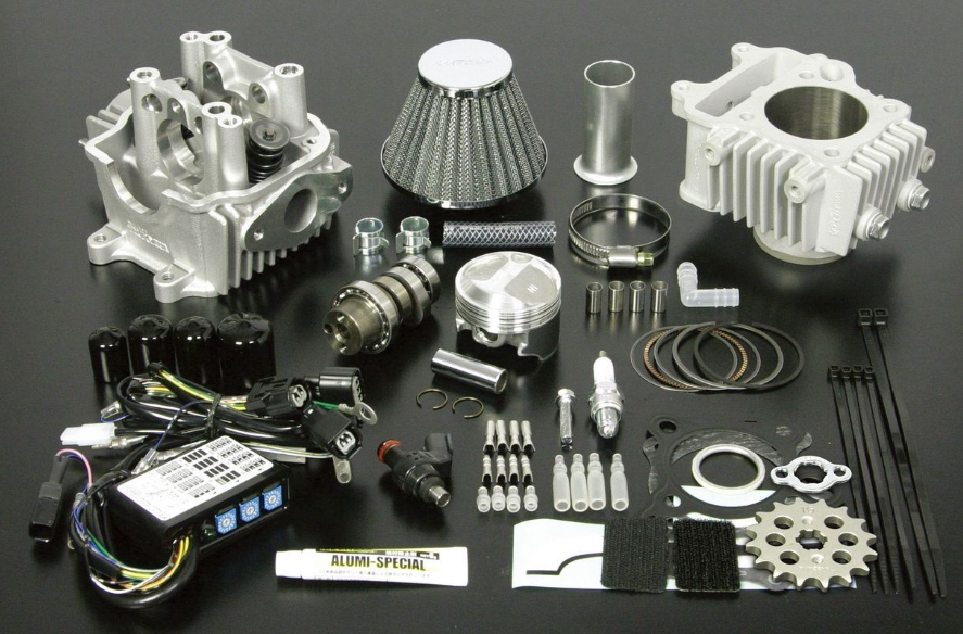 Collection of mechanical parts and tools on a dark surface