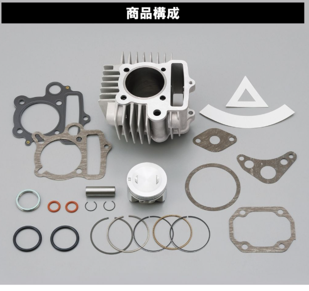 Engine cylinder head assembly with various gaskets and seals on a gray background