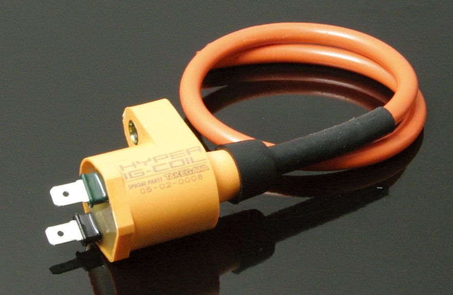 Coiled orange cable with a yellow connector on a black background