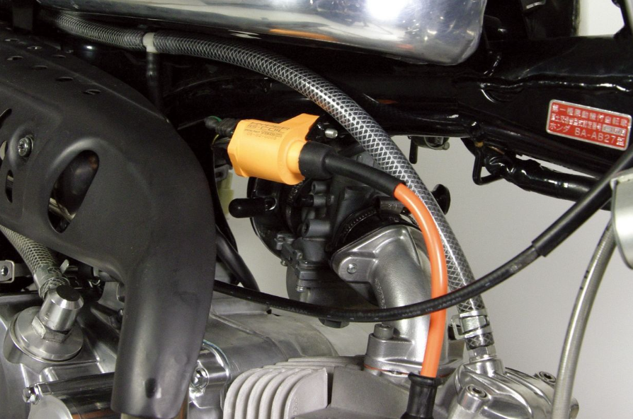 Close-up of a motorcycle engine with visible wiring and components.