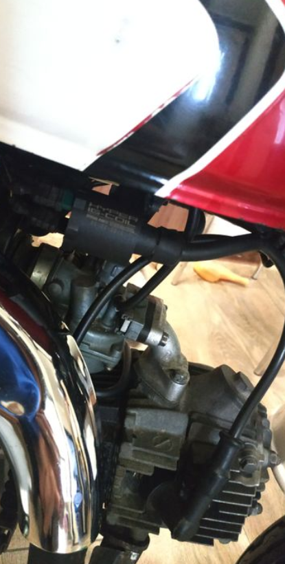 Close-up of a motorcycle engine and exhaust system.