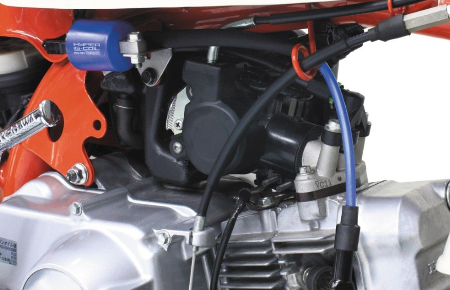 Close-up of a motorcycle engine with visible components and wiring.