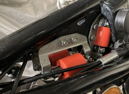 Close-up of a mechanical component with red and black parts on a vehicle.