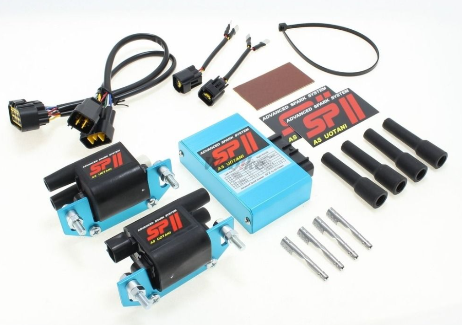 Automotive parts including a blue box, black connectors, and metal components on a white background.