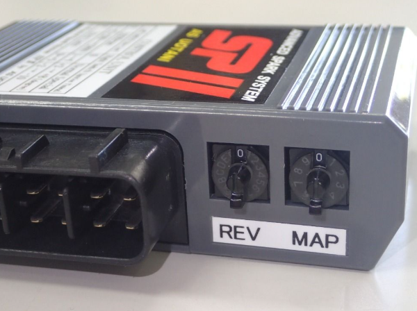Car electronic module with 'REV' and 'MAP' labels on a white background