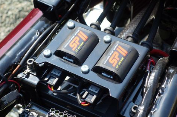 Close-up of a car's engine with electronic components labeled 'STP'.