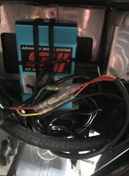 Car stereo system with wiring and 'Advanced Sound System' label.