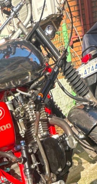 Close-up of a red motorcycle with visible branding and license plate.