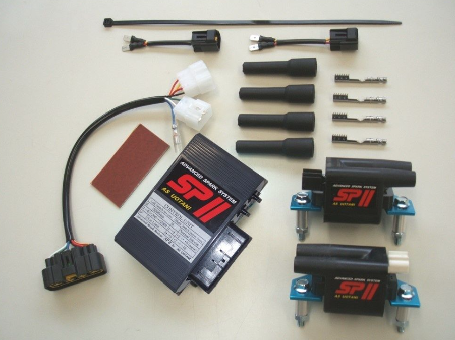 Automotive parts including a black box labeled 'SP II' on a beige background