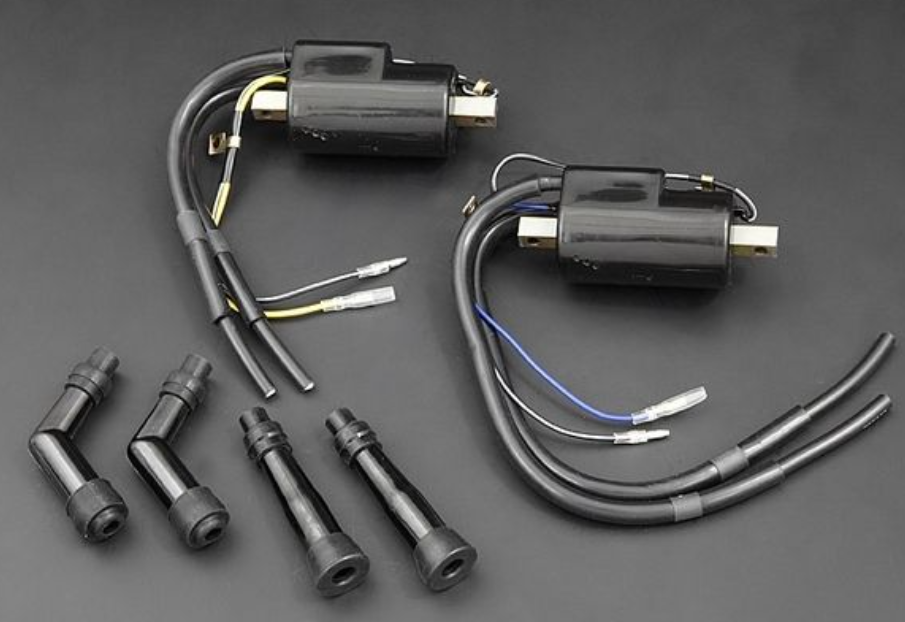 Set of ignition coils and connectors on a dark background