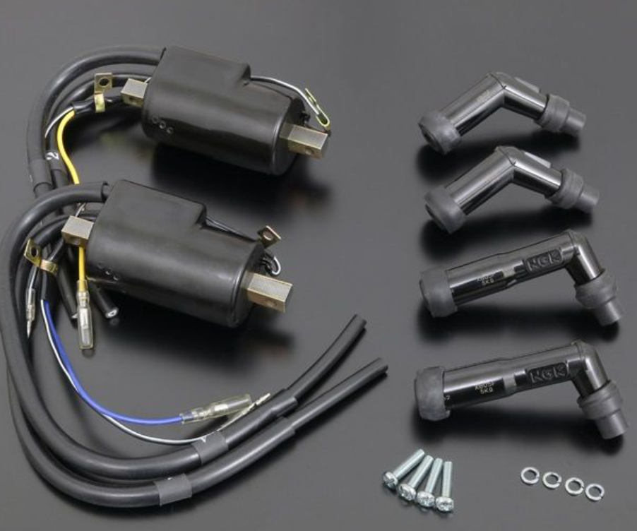 Motorcycle ignition components including coils and connectors on a dark background