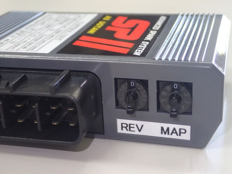 Car tuning device with 'REV' and 'MAP' labels on a white background