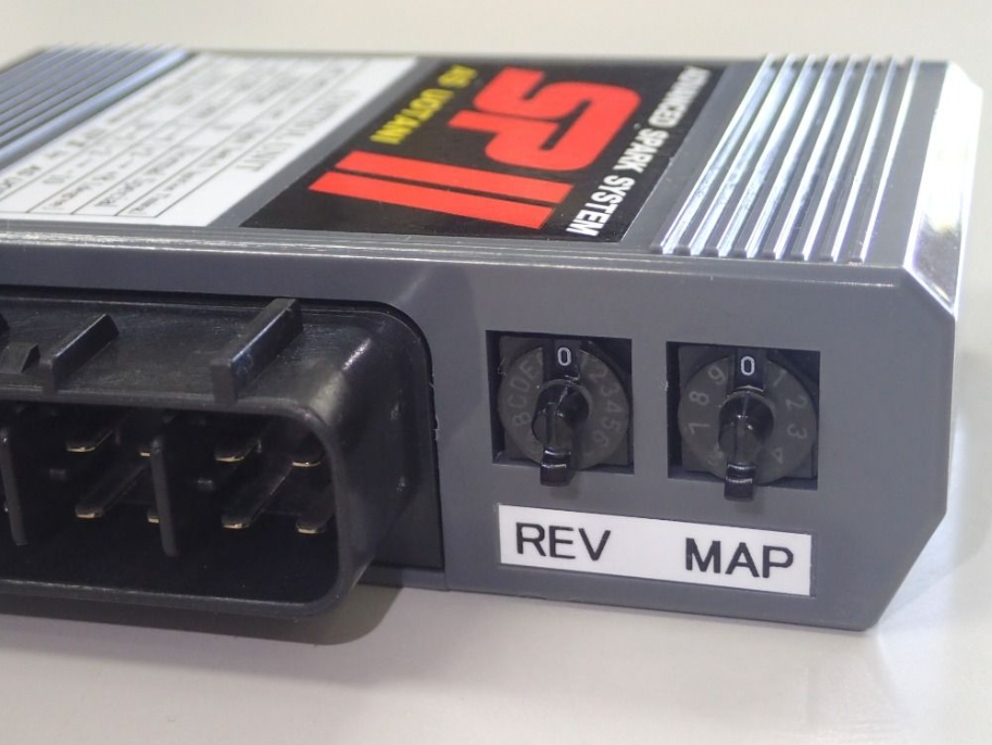 Car tuning device with 'REV' and 'MAP' labels on a white background