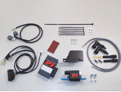 Automotive parts kit including wires, connectors, and metal components on a gray background