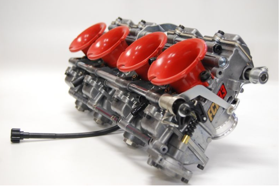 Car engine block with red intake runners on a white background