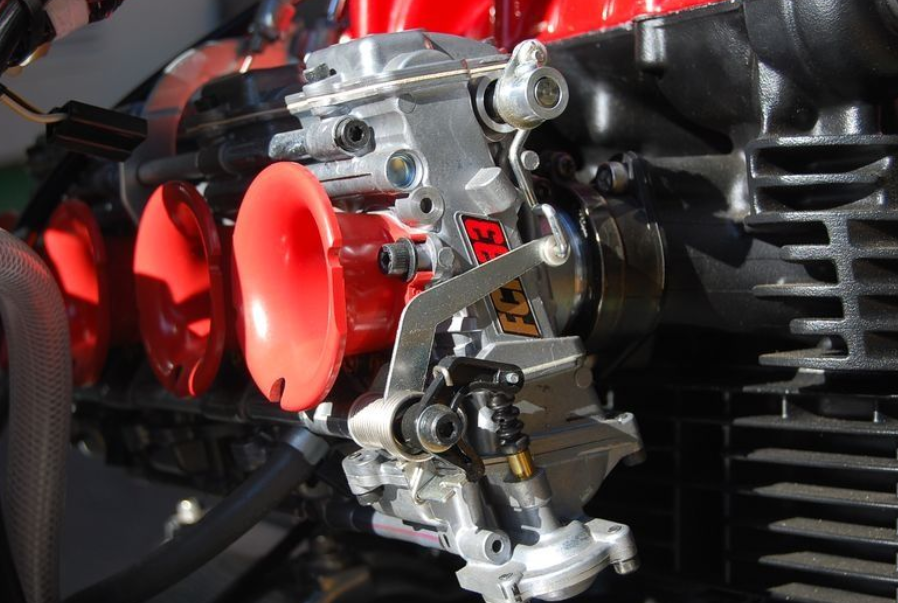 Close-up of a motorcycle engine with red exhaust pipes
