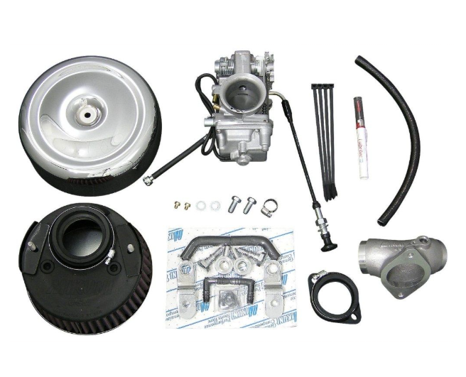 Collection of automotive parts including a carburetor, pulleys, and hoses on a white background.