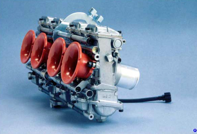 Model of a four-cylinder engine with red valves on a blue background