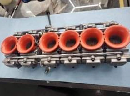Engine block with orange cylinders on a blue surface