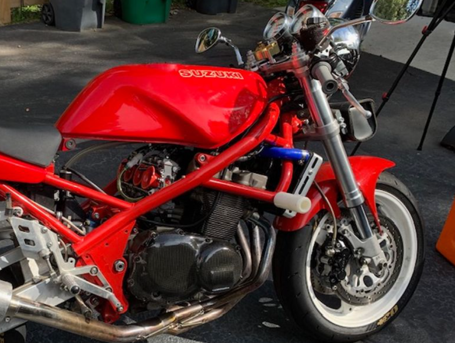Red motorcycle with visible branding on a dark surface