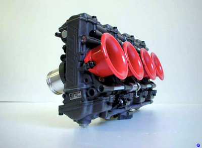 Car engine block with red components on a white background