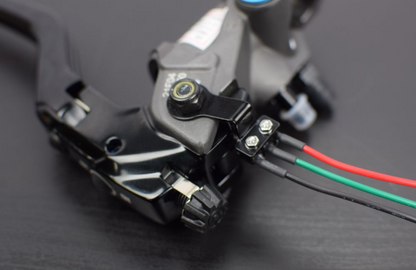 Close-up of a mechanical component with wires on a dark background