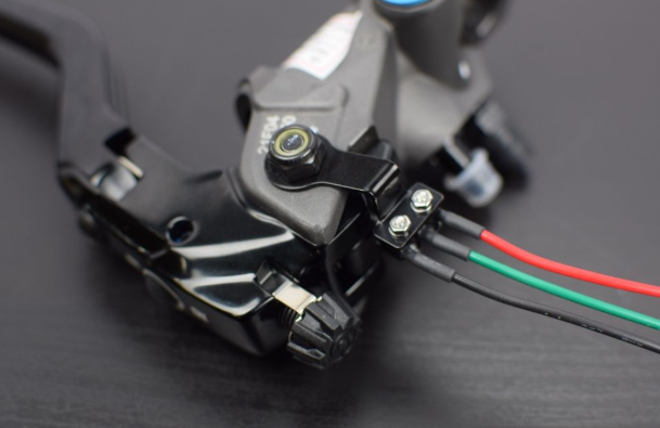 Close-up of a mechanical component with wires on a dark background