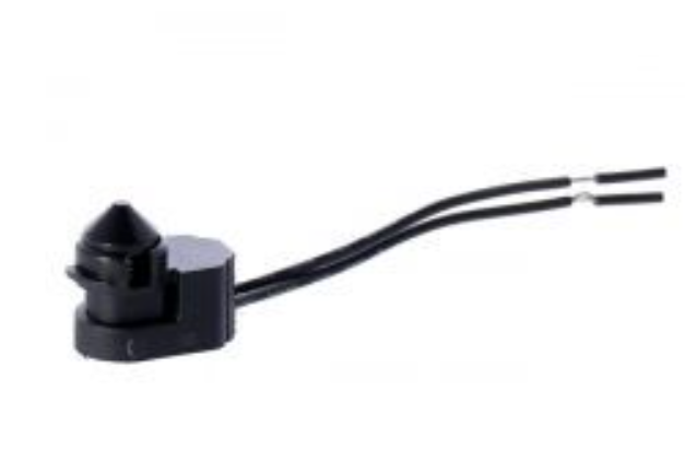 Small black electronic component with wires on a white background