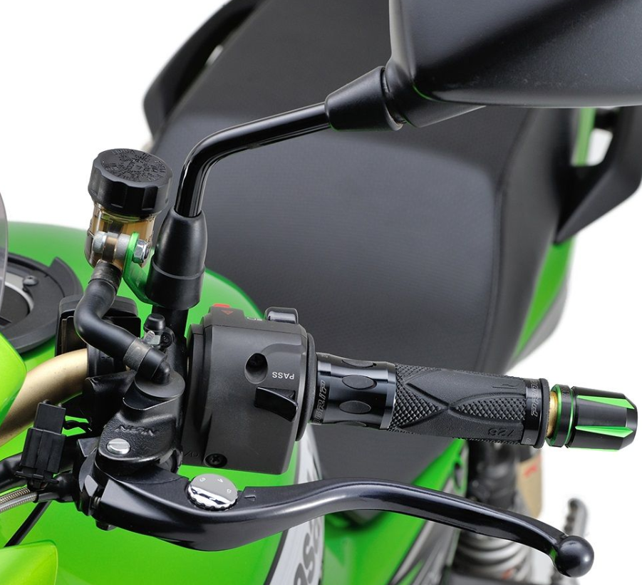 Close-up of a motorcycle handlebar with green background