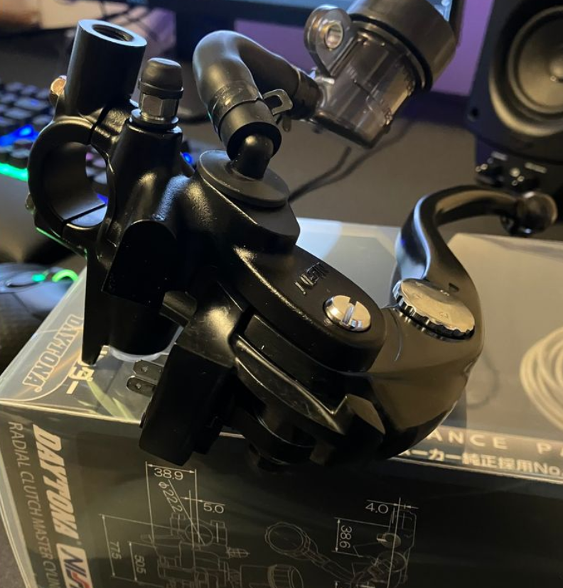Close-up of a black mechanical component on a box with technical drawings