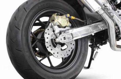 Close-up of a motorcycle wheel with disc brake on a white background