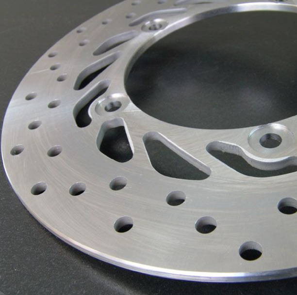 Close-up of a metallic brake disc on a dark background