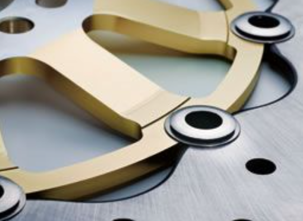 Close-up of a mechanical component with gold and silver metal parts.