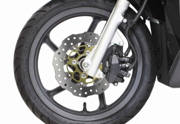 Close-up of a motorcycle wheel with disc brake on a white background