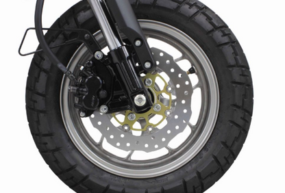 Close-up of a motorcycle wheel with tire and suspension on a white background