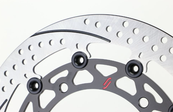Close-up of a motorcycle disc brake rotor with bolts on a white background