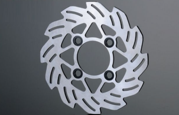 Metallic brake disc on a gray background