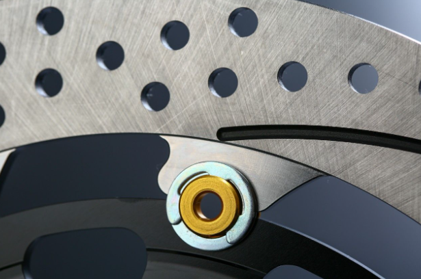 Close-up of a motorcycle brake disc with a yellow center