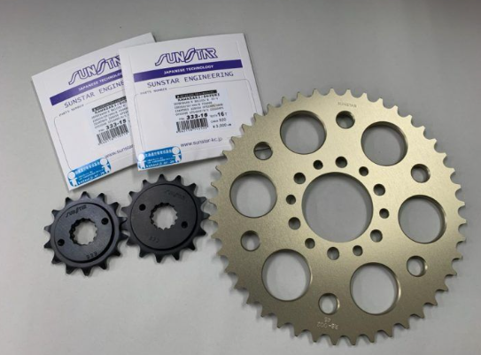 Mechanical gears and Sunstar Engineering packaging on a gray background