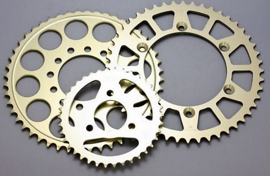 Two brass sprockets on a gray background