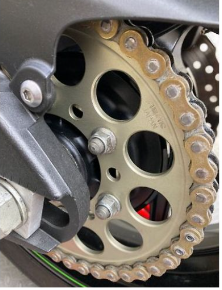 Close-up of a motorcycle chain and sprocket system