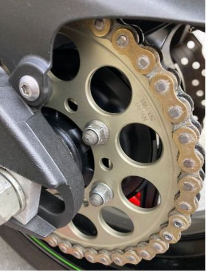 Close-up of a motorcycle chain and sprocket system