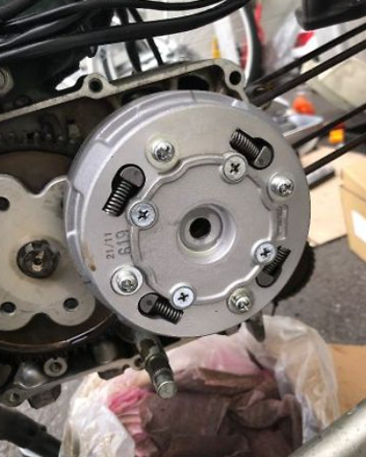 Close-up of a motorcycle engine component with visible branding.