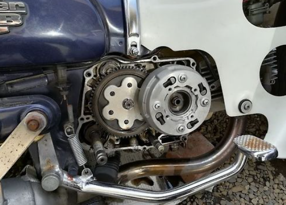 Close-up of a motorcycle engine with visible mechanical components.